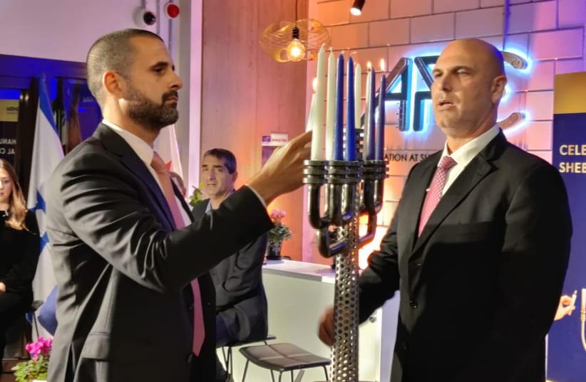  Bahraini ambassador to Israel, H.E. Khaled Yusuf Al Jalahama, and Mr. Yoel HarEven, director of the international division and resource development at Sheba Medical Center, light Chanukah candles at an historic ceremony celebrating hope and coexistence (photo credit: Courtesy)