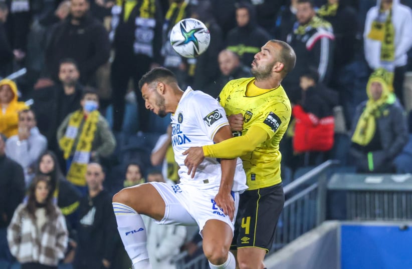  MACCABI TEL AVIV (in white) and Beitar Jerusalem dueled on Sunday night in the capital, with the visitors claiming a 2-1 victory after an exciting contest (photo credit: DANNY MARON)