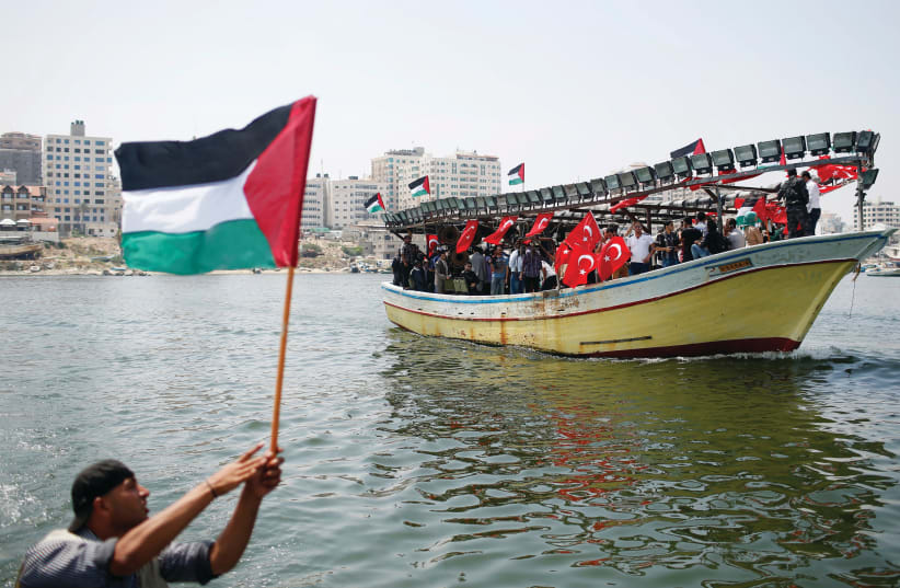  ACTIVISTS RIDE a boat decorated with Turkish and Palestinian flags at the port in Gaza City ahead of an anniversary of the ‘Mavi Marmara’ flotilla incident. (photo credit: MOHAMMED SALEM/REUTERS)