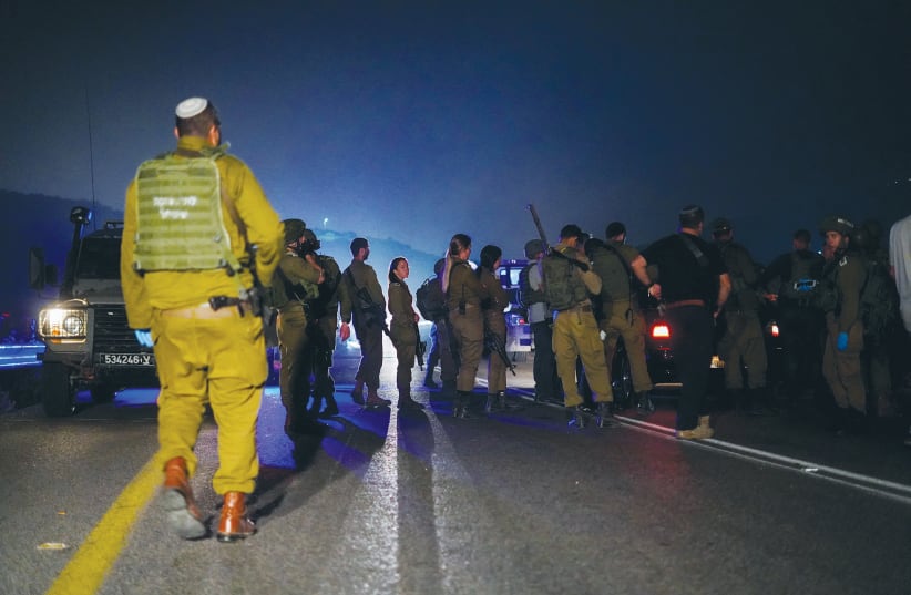  SECURITY FORCES inspect the scene of a shooting attack in Samaria earlier this year. (photo credit: HILLEL MAEIR/FLASH90)