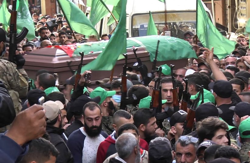  Members of Palestinian group Hamas carry their weapons during a funeral in Tyre (photo credit: Ali Hankir/Reuters)