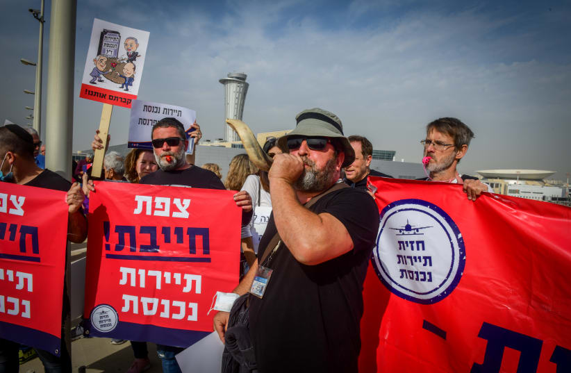  Independent business owners and workers from the tourism sector protest, calling for financial support from the Israeli government, outside the Ben Gurion International Airport, on December 13, 2021 (photo credit: AVSHALOM SASSONI/FLASH90)
