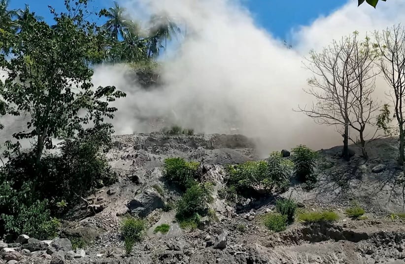  A still image from a social media video shows dust disturbances on side of hill after an earthquake in Nagekeo, Indonesia (photo credit: REUTERS)