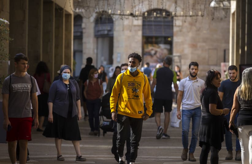  People walk some with face masks at the Mamilla Mall in Jerusalem, October 13, 2021.  (photo credit: OLIVIER FITOUSSI/FLASH90)