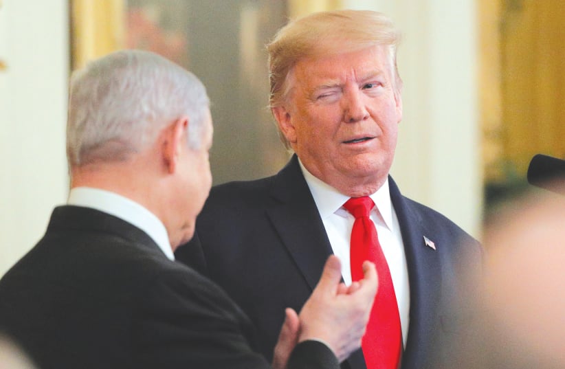  THEN-US PRESIDENT Donald Trump winks at then-prime minister Benjamin Netanyahu at the White House last year.  (photo credit: BRENDAN MCDERMID/REUTERS)