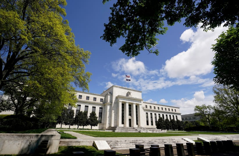 The Federal Reserve building is set against a blue sky in Washington, US, May 1, 2020. (photo credit: REUTERS/KEVIN LAMARQUE/FILE PHOTO)