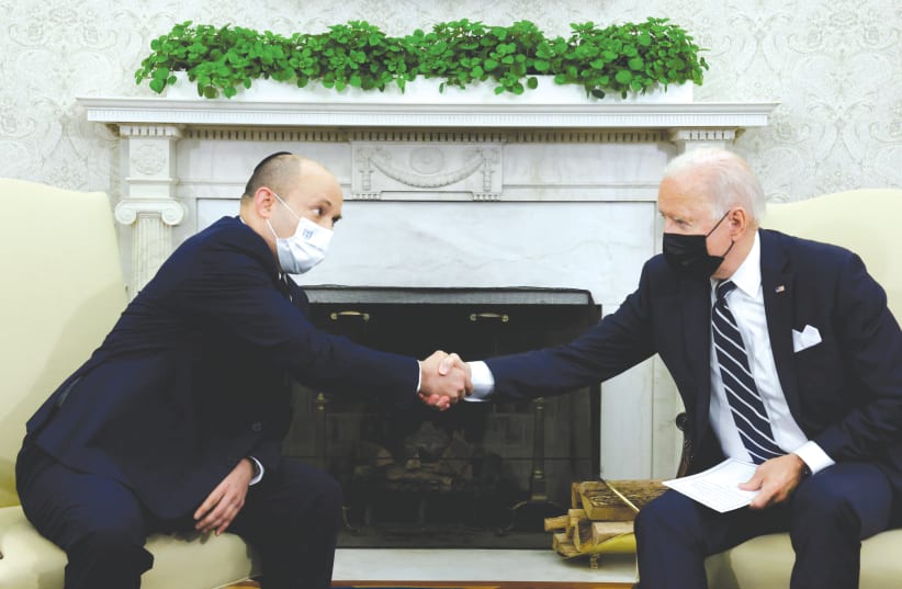  US PRESIDENT Joe Biden and Prime Minister Naftali Bennett shake hands during a meeting in the Oval Office in August. (photo credit: REUTERS/JONATHAN ERNST)