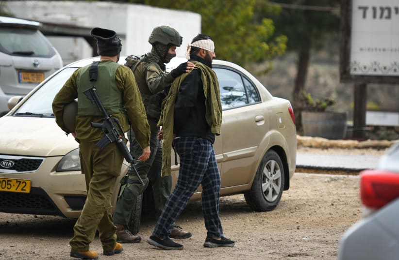  IDF arrest a Palestinian man outside Shavei Shomron, in the West Bank, on December 17, 2021, following the fatal shooting attack near Homesh that killed 25-year-old Yehuda Dimentman. (photo credit: SRAYA DIAMANT/FLASH90)