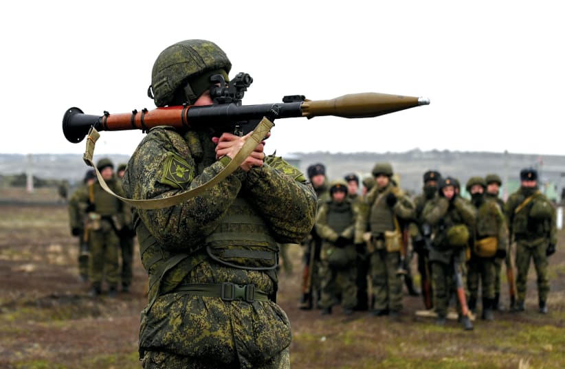 A grenade launcher operator of the Russian armed forces takes part in combat drills last week in the Rostov region of Russia near Ukraine. (photo credit: SERGEY PIVOVAROV/REUTERS)