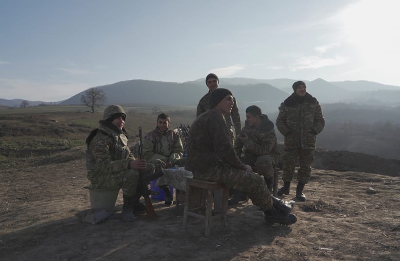 Ethnic Armenian soldiers gather at their fighting positions near the village of Taghavard in the region of Nagorno-Karabakh, January 11, 2021. (photo credit: REUTERS/ARTEM MIKRYUKOV)