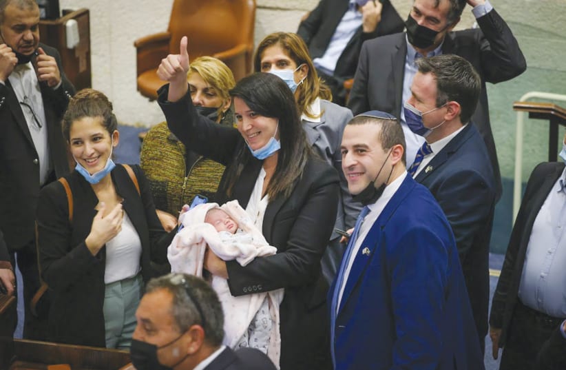 MK Shirley Pinto brings her six-day-old baby to the Knesset Wednesday, enabling her to take part in a vote. (photo credit: NOAM MOSKOVICH/KNESSET)