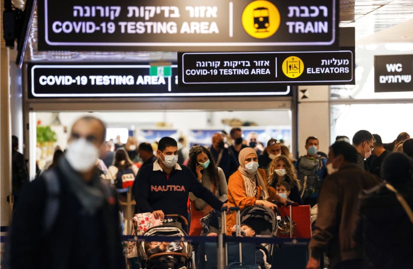  Travelers exit the coronavirus disease (COVID-19) pandemic testing area at Ben Gurion International Airport as Israel imposes new restrictions on November 28, 2021. (photo credit: AMIR COHEN/REUTERS)