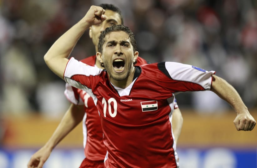  Syria's Firas Al Khatib celebrates his goal against Japan after taking a penalty kick during their 2011 Asian Cup Group B soccer match at Qatar Sports Club stadium in Doha January 13, 2011 (photo credit: Louafi Larbi/Reuters)