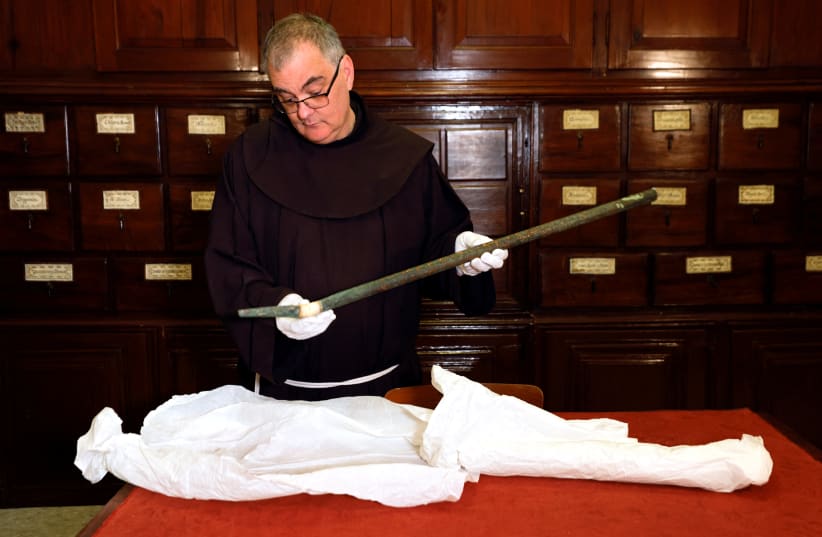  Father Stephane, Franciscan Friar and Liturgist of the Custody of the Holy Land holds an organ pipe, part of a collection from the 12th century that researchers say used to play music inside Bethlehem's Church of the Nativity and was hidden together with bells by Crusaders. (photo credit: AMIR COHEN/REUTERS)