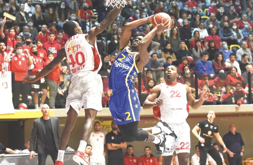  KEENAN EVANS (with ball) and Maccabi Tel Aviv had their hands full against Hapoel Galil Elyon, but the yellow-and-blue was able to pull out an 88-84 overtime victory. (photo credit: BERNEY ARDOV)