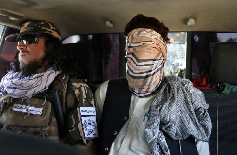  A SUSPECTED ISIS member sits blindfolded in a Taliban Special Forces car in Kabul, Afghanistan, Sept. 5. (photo credit: WANA VIA REUTERS)