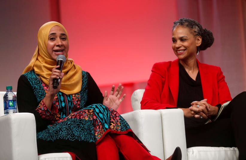 Zahra Billoo (L), Executive Director, Council of Islamic Relations addresses the audience as Maya Wiley, civil rights activist, listens during the three-day Women's Convention at Cobo Center in Detroit, Michigan, US, October 28, 2017. (photo credit: REUTERS/REBECCA COOK)