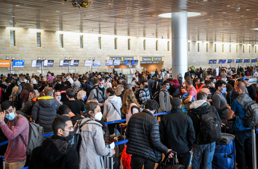 Travelers seen at the Ben Gurion International Airport, on December 22, 2021. (photo credit: FLASH90)