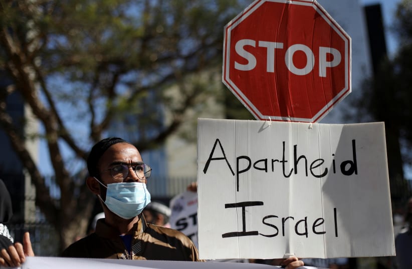  South African demonstrators and BDS activists hold placards during a protest in May 2021 outside the Israel Trade offices in Sandton, SA, following a flare-up of Israeli-Palestinian violence (photo credit: SIPHIWE SIBEKO/REUTERS)