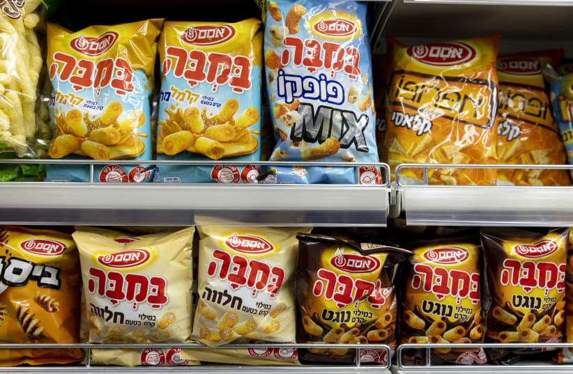 Packages of Bamba - made by Osem - on a shelf in a Jerusalem grocery store on December 29, 2021. (photo credit: OLIVIER FITOUSSI/FLASH90)
