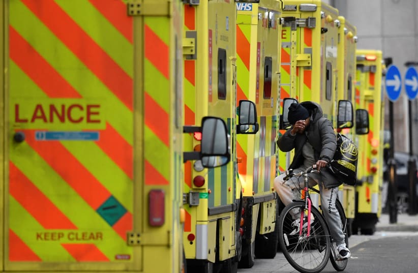  Ambulances parked amid the COVID-19 pandemic outside the Royal London Hospital in London (photo credit: REUTERS/TOBY MELVILLE)