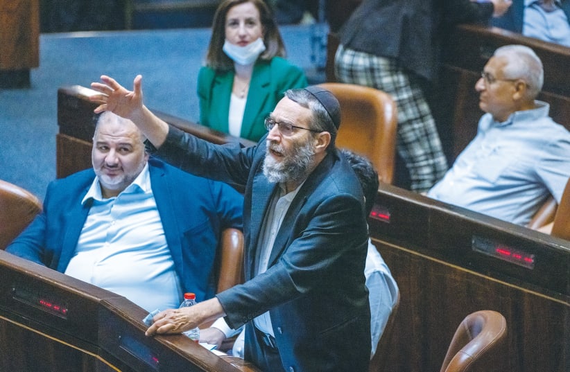  MK MOSHE GAFNI stands in the Knesset plenum to voice an argument as MK Mansour Abbas watches alongside him. (photo credit: OLIVER FITOUSSI/FLASH90)
