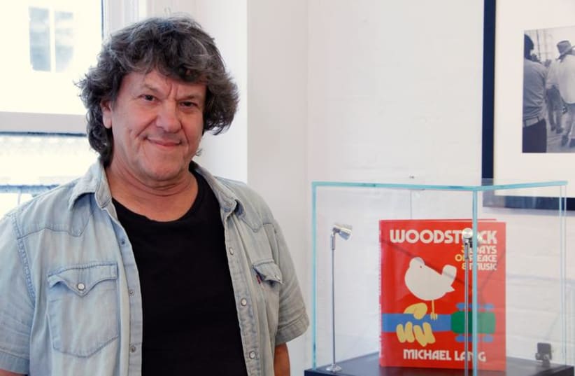  Woodstock producer Michael Lang poses during a photo exhibit that celebrates the 50th anniversary of Woodstock in New York, August 9, 2019. (photo credit: REUTERS/ALICIA POWELL)