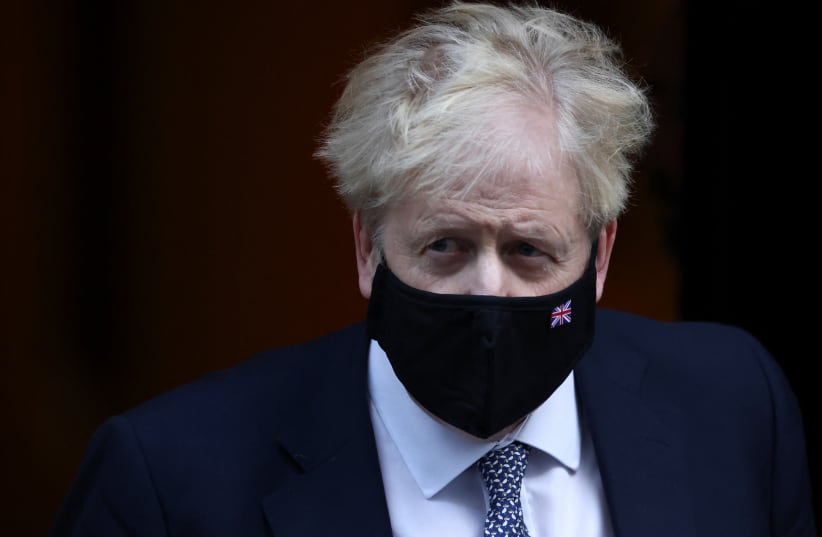 British Prime Minister Boris Johnson walks outside Downing Street in London, Britain, January 12, 2022. (photo credit: REUTERS/HENRY NICHOLLS)