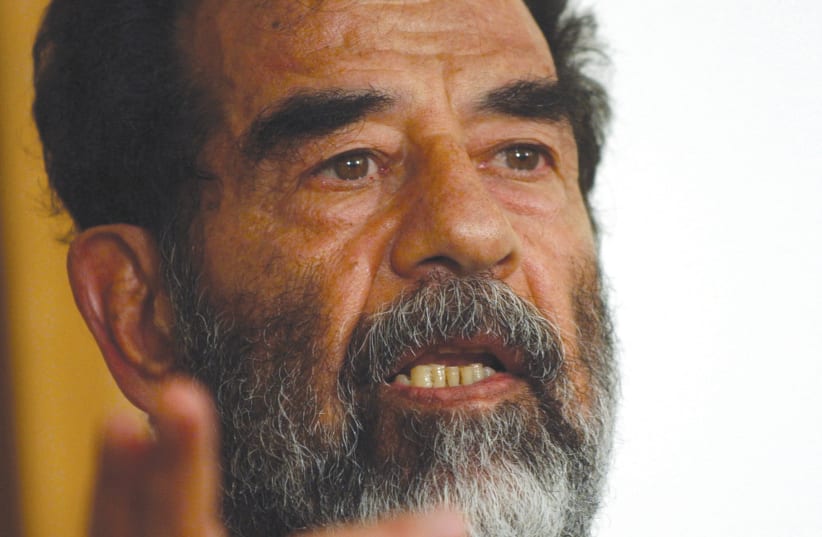  Former Iraqi leader Saddam Hussein addresses the court at his trial in 2004. (photo credit: WIKIPEDIA)