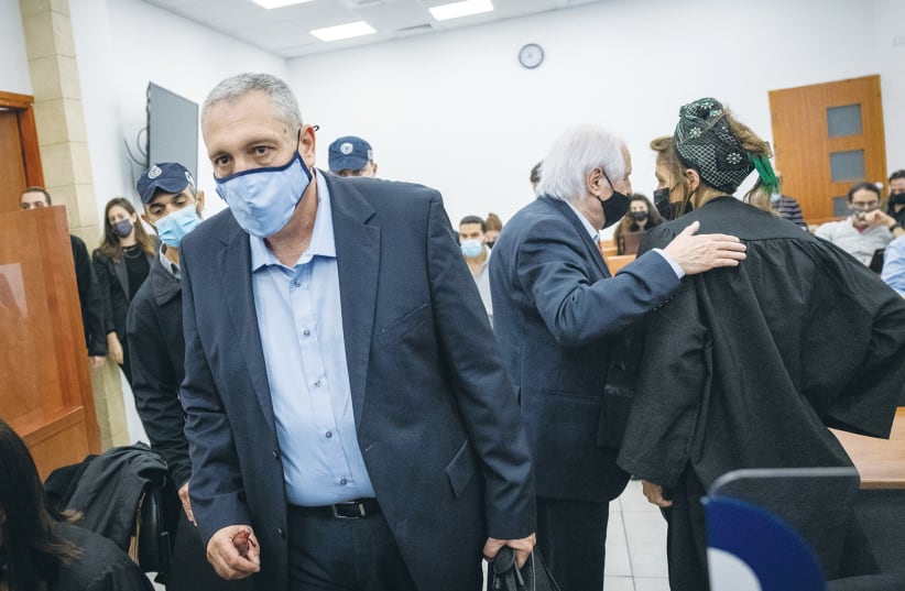 Nir Hefetz, with Shaul Elovitch behind him, arrives at the Jerusalem District Court last month for proceedings in the Netanyahu trial. (photo credit: YONATAN SINDEL/FLASH90)