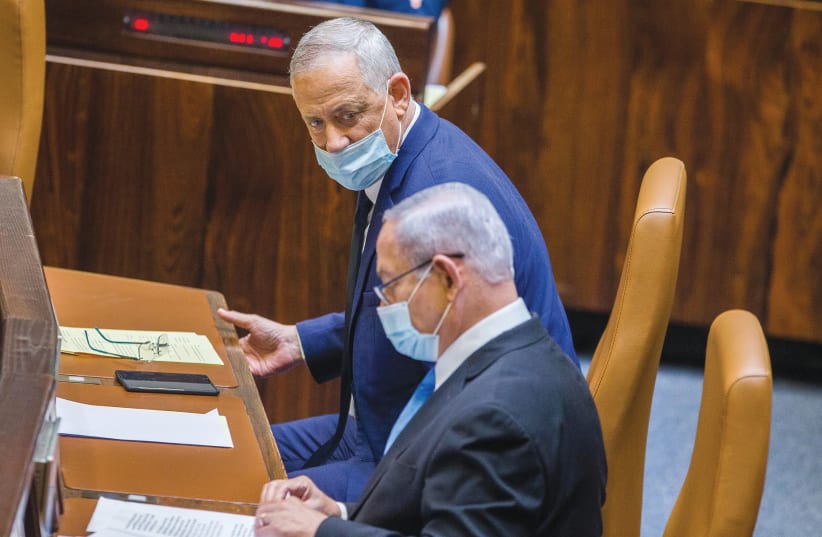  THEN-PRIME MINISTER Benjamin Netanyahu and Defense Minister Benny Gantz sit at the government table in the Knesset plenum in this photo from 2020. The formation of the Netanyahu-Gantz coalition created an unprecedented form of government.  (photo credit: OREN BEN HAKOON/FLASH90)