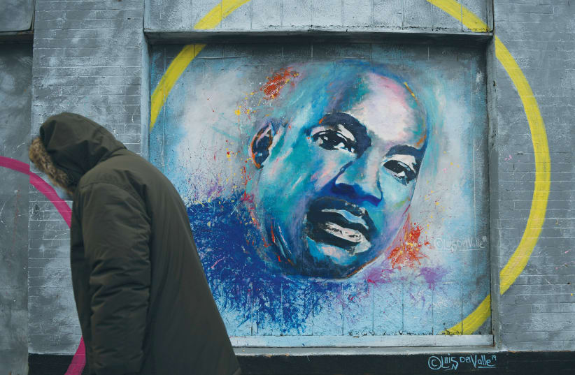  A PERSON passes by a mural of Martin Luther King Jr. in Washington, DC, last January. (photo credit: REUTERS/BRANDON BELL)