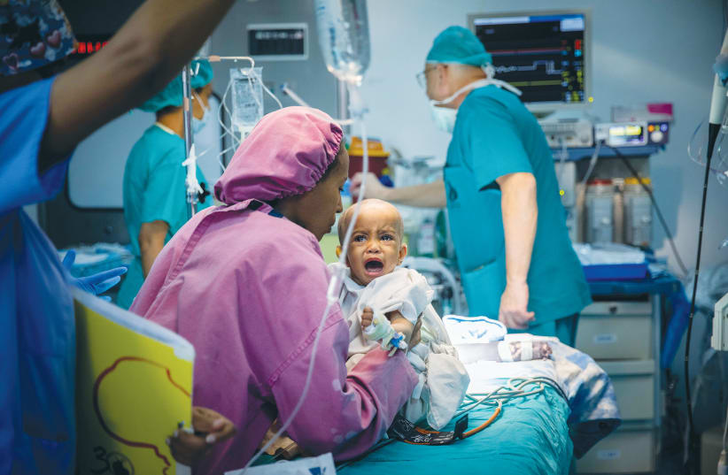  A MOTHER holds her child who is about to undergo open-heart surgery at the Children’s Cardiac Center in Addis Ababa, during a Save a Child’s Heart mission in 2019. (photo credit: YONATAN SINDEL/FLASH90)