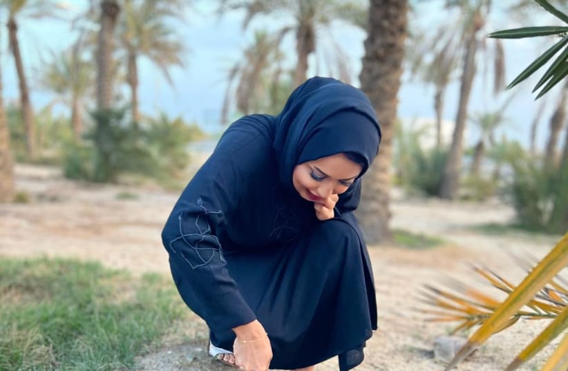  A Bahraini woman plants a tree in honor of Tu Bishvat on January 17, 2021. (photo credit: Sharaka)