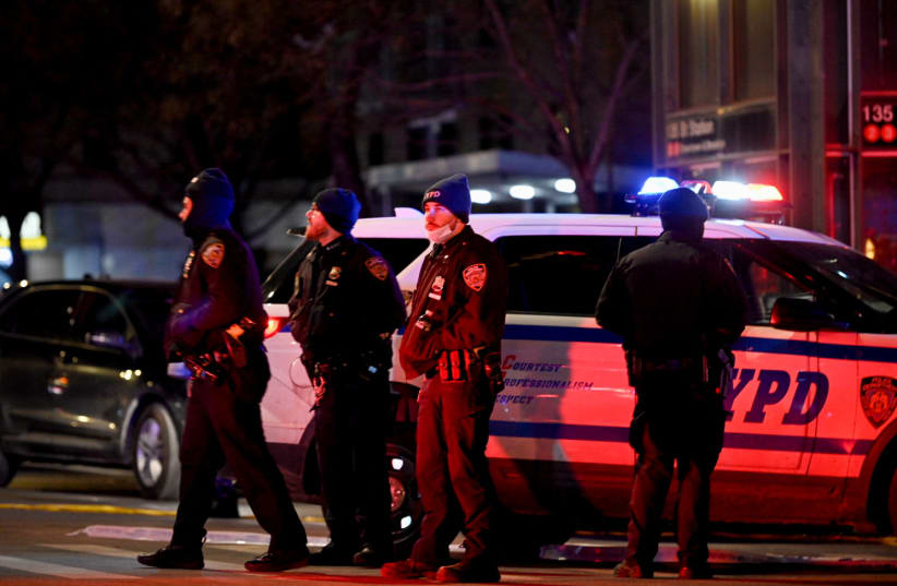 Emergency personnel respond at the scene where NYPD officers were shot while responding to a domestic violence call in the Harlem neighborhood of New York City, US, January 21, 2022. (photo credit: REUTERS/LLOYD MITCHELL)
