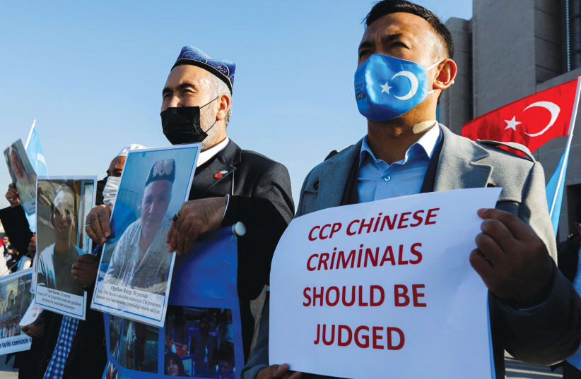  ETHNIC UIGHUR men take part in a protest against China, in Istanbul earlier this month. (photo credit: DILARA SENKAYA/REUTERS)