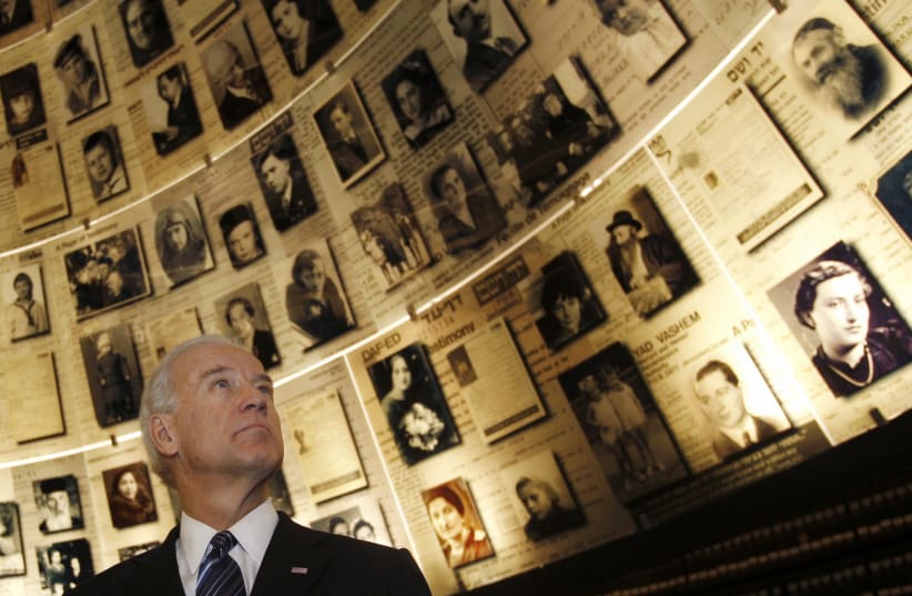 US VP Joe Biden looks at pictures of Jews killed in the Holocaust during a visit to the Hall of Names at the Yad Vashem Holocaust History Museum in Jerusalem March 9, 2010 (photo credit: RONEN ZVULUN/REUTERS)
