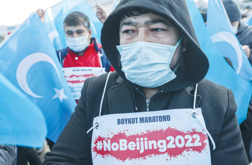  DEMONSTRATORS FROM China’s Uighur Muslim ethnic group protest outside a Turkish Olympic Committee building in Istanbul last week, calling for a boycott of the Winter Olympics in Beijing. (photo credit: UMIT BEKTAS/REUTERS)
