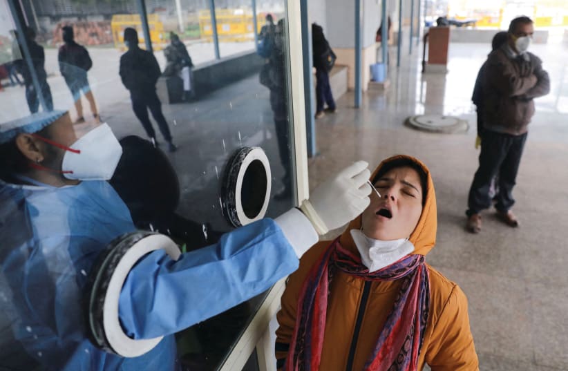  A WOMAN takes a COVID-19 test at a hospital in New Delhi, earlier this month. When India suffered a severe COVID-19 wave last April, Israel sent planeloads of respirators and other medical aid. (photo credit: REUTERS/ANUSHREE FADNAVIS)
