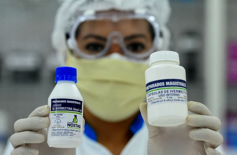  FILE PHOTO: A pharmacist holds the anti-parasite drug ivermectin for sale to the public with a medical prescription as Bolivia's Ministry of Health said it can be used under proper medical protocol. Santa Cruz, Bolivia May 19, 2020. (photo credit: REUTERS/Rodrigo Urzagasti/File Photo)