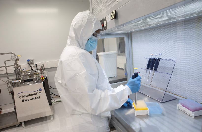  A production scientist works with samples during a visit by representatives of the Medicines Patent Pool, France and other European Union member states, at the Afrigen Biologics' site in Cape Town, South Africa, February 3, 2022. (photo credit: REUTERS/Shelley Christians)