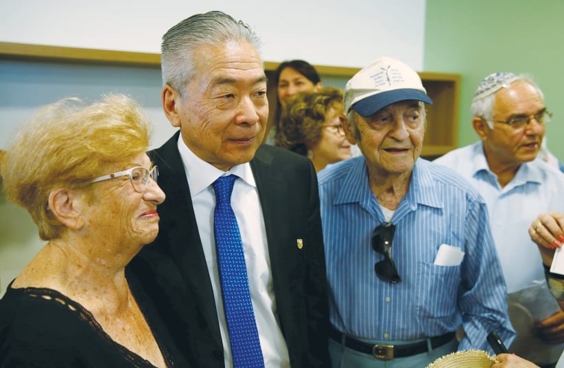  NOBUKI SUGIHARA, son of Japanese diplomat Chiune Sugihara, stands next to Soli Ganor (right), one of thousands of Jews saved by Sugihara during World War II. The photo was taken during a street-naming ceremony in honor of the late diplomat in Netanya in 2016. (photo credit: BAZ RATNER/REUTERS)