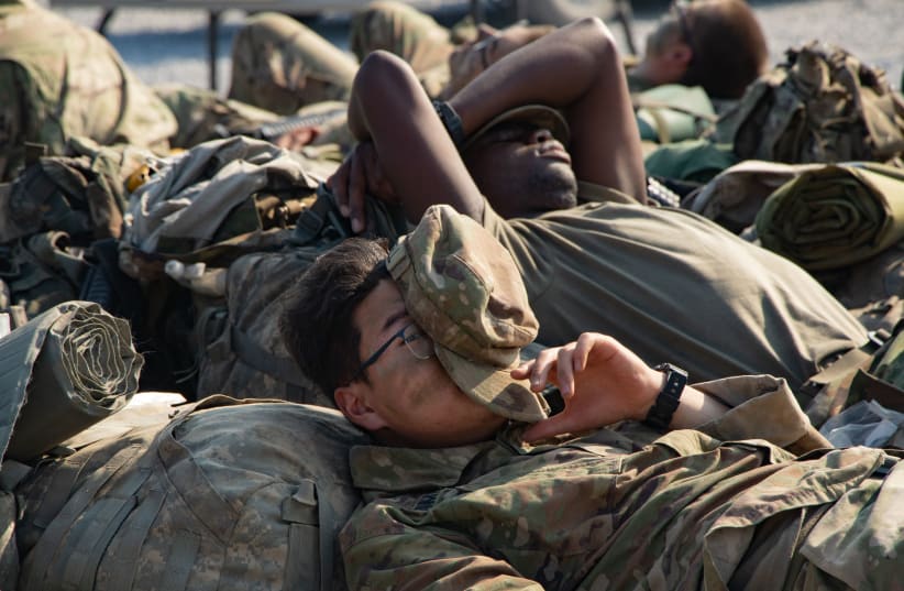  US Army soldiers sleep during a rare opportunity for a nap (photo credit: FLICKR)