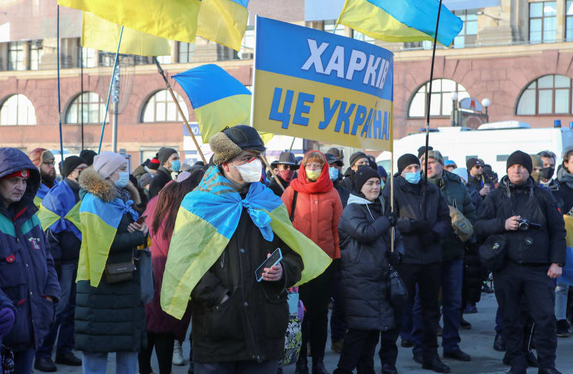 People take part in the Unity March, which is a procession to demonstrate the patriotic spirit of local residents amid growing tensions with Russia, in Kharkiv, Ukraine February 5, 2022. A placard reads: "Kharkiv is Ukraine". (photo credit: REUTERS/VYACHESLAV MADIYEVSKYY)