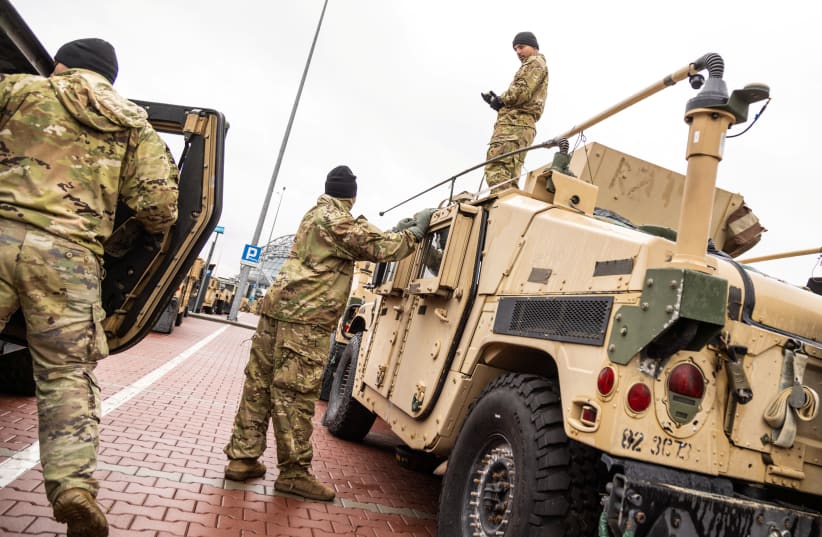 US military Humvees (High Mobility Multipurpose Wheeled Vehicle) are parked outisde the G2A Arena near the Rzeszow-Jasionka Airport, in Jasionka, Poland, February 9, 2022. (photo credit: REUTERS/KUBA STEZYCKI)