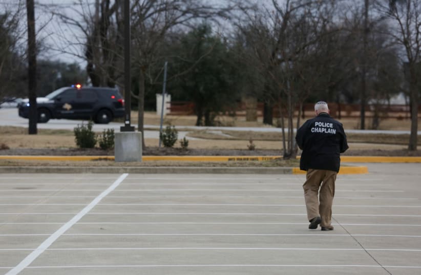  A police chaplain walks through the area where Malik Faisal Akram took Rabbi Charlie Cytron-Walker and three other congregants hostage during prayers at Congregation Beth Israel in Colleyville, Texas, on January 15. (photo credit: Shelby Tauber/Reuters)