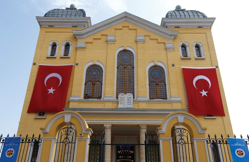  TURKISH FLAGS are seen on the facade of the restored Great Synagogue before a reopening ceremony in Edirne, western Turkey, in 2015.  (photo credit: MURAD SEZER/REUTERS)