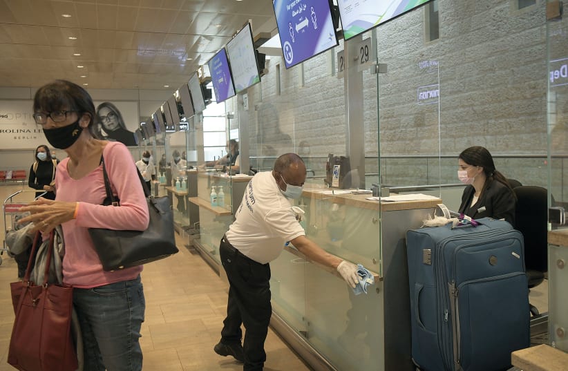  PASSENGERS CHECK IN at Ben-Gurion Airport. We all need to be on the lookout for phishing or fake emails or messages to trick people into falling for a scam. (photo credit: FLASH90)