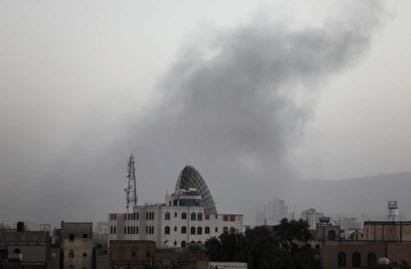  Smoke rises from the site of a Saudi-led air strike on the telecommunications compound in Sanaa, Yemen February 14, 2022.  (photo credit: REUTERS/KHALED ABDULLAH)