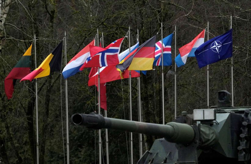  NATO and member states flags flutter during German Defence Minister Christine Lambrecht's visit to German troops in Rukla military base, Lithuania February 22, 2022 (photo credit: INTS KALNINS / REUTERS)